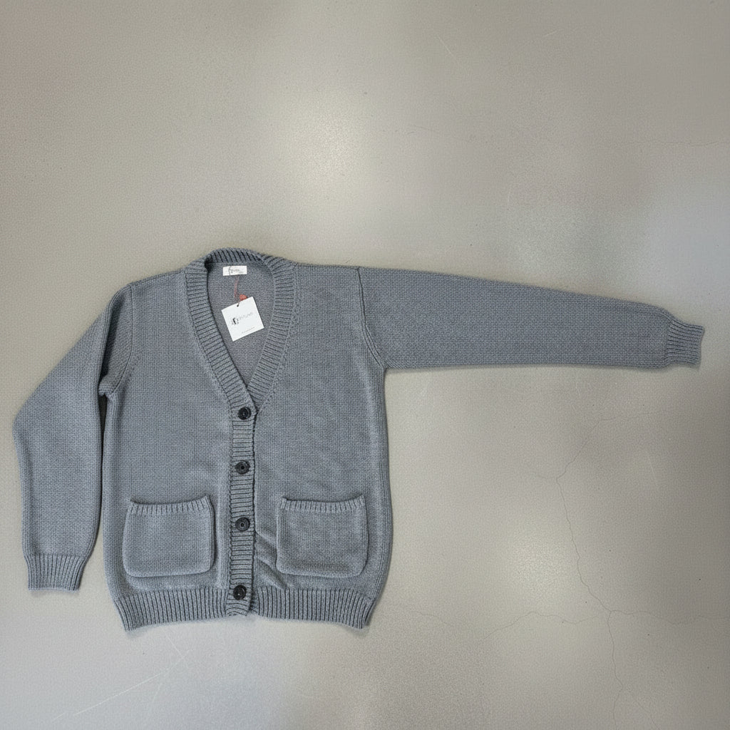 Gray sweater on a cement floor with one arm open